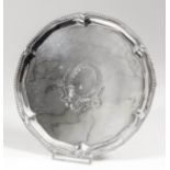 A George III silver circular salver with shaped and moulded rim, with bead mounts, the centre
