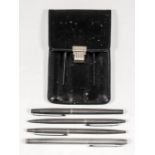 A Caran-d'Ashe Swiss silvery metal four piece pen and pencil set, in Asprey's black leather case for