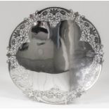 A George VI silver circular dish of lobed outline, the rim pierced with scroll and floral