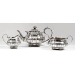 A George IV silver circular three piece tea service with gadroon mounts, part reeded and fluted