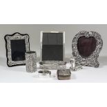 An Elizabeth II silver rectangular photograph frame of shaped outline, embossed with cartouche and