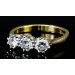 An 18ct gold and white gold mounted three stone diamond ring, set with three brilliant cut diamonds,