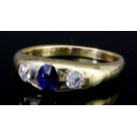 An 18ct gold sapphire and diamond three stone "Gypsy" ring, the band inset with oval sapphire to
