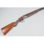 A 12 bore over and under shotgun by Merkel, Serial No. 88981, the 26ins blued steel barrels with