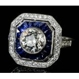 A good 1920's silvery coloured metal diamond and sapphire octagonal faced "halo" ring the collet set