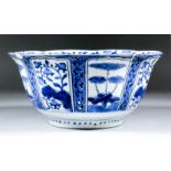 A Chinese blue and white porcelain bowl, the ribbed panels painted alternately with flowering