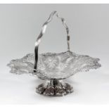 An Edward VII silver circular basket, the shaped and moulded rim cast with shell and scroll ornament