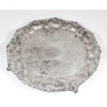 A plated circular tray, the rim of lobed form and cast with fruiting vines, the centre engraved with