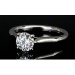 A modern platinum mounted solitaire diamond ring, set with a brilliant cut diamond of