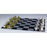 An Elizabeth II silver and silver gilt travelling chess set, with interlocking cylindrical pieces,