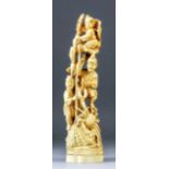 A Japanese carved ivory Okimono carved with three fishermen and a basket from which emerges a