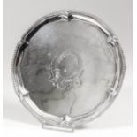 A George III silver circular waiter with shaped and moulded rim and bead mounts, the centre engraved