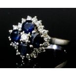 A modern 18ct white gold mounted sapphire and diamond cluster ring, set with four sapphires, each