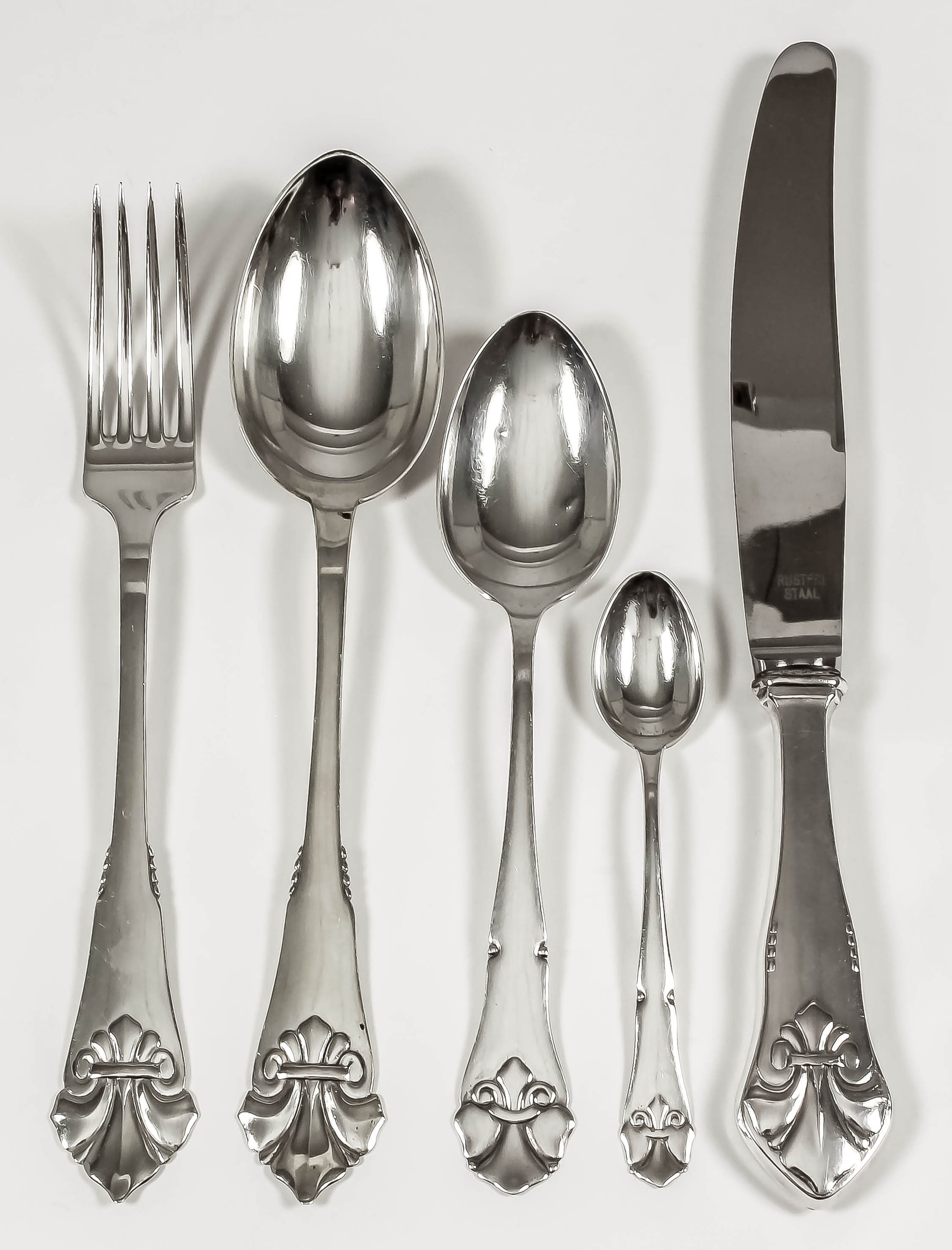 A Danish silver harlequin part table service, the shaped handles with leaf pattern finials, by