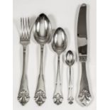 A Danish silver harlequin part table service, the shaped handles with leaf pattern finials, by