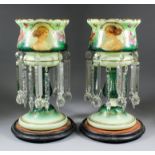 A pair of early 20th Century green and white opaque glass lustre vases painted with the profile bust