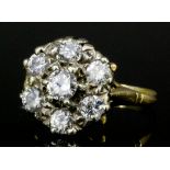 An early 20th Century 18ct gold mounted all diamond set flowerhead pattern ring, set with seven