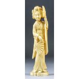A Japanese carved ivory Okimono of a Geisha holding two fans, 9ins (22.8cm) high