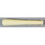 A 19th/20th Century turned ivory miniature truncheon with ribbed handle, 7.25ins