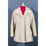 A lady's blonde mink jacket, lined, size 10-12, 30ins long