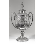 A late Victorian silver two handled prize cup and cover, the cover cast with classical female figure