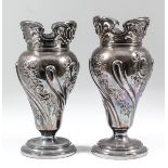 A pair of late Victorian silver baluster shaped vases, the pierced rims with scroll mounts, the