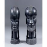 A pair of carved ebony African busts of a male and female, each 9ins high