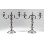 A pair of Elizabeth II silver two light candelabra, each with double C scroll branches and knop