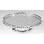 A George V silver circular low tazza, the plain top with pierced fan pattern gallery on circular