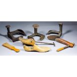 A collection of shoe makers/cobblers equipment, including - Three cast iron three way lasts (two