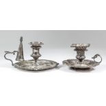 A late Victorian silver circular chamber candlestick with gadroon shell and scroll mounts and scroll