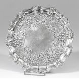 A George II silver circular waiter, the shaped and moulded rim with shell castings, the centre