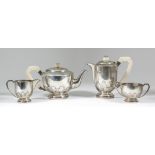 George V Harlequin silver circular four piece tea service of Art Deco design, the lower bodies