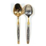 A pair of modern Russian silvery metal, niello and silvery gilt metal table spoons, decorated with