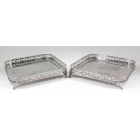 A pair of Dutch silvery metal square galleried trays, the pierced sides with trailing leaf scroll