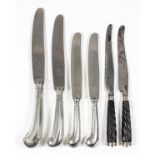 A set of twelve Dutch silvery metal handled table knives, and eleven dessert knives with silver