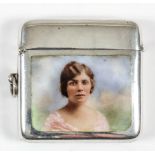 A George V silver and enamel vesta case, the face enamelled with a shoulder length portrait of a