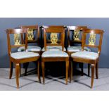 A set of six 19th Century French fruitwood and parcel gilt dining chairs in the "Empire" manner, the