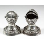 A pair of late Victorian silver pounce pots modelled in the form of an Arnet style Helm with lifting