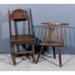 A 17th/18th Century primitive stick back low chair with wood seat on three legs, and a 19th