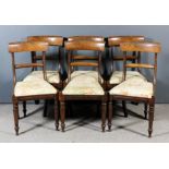 A set of six late Georgian mahogany dining chairs with plain curved crest rails and splats, the