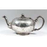 An early Victorian silver circular teapot of squat form with pomegranate and leaf pattern finial,