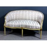 An early 20th Century French cream painted and gilt framed tub shaped two seat settee with moulded