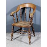 A 19th Century oak and elm seated Bergere armchair with horseshoe shaped back, on spindle turned