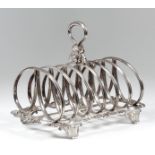 A William IV silver six division toast rack with moulded double-loop divisions, the loop handle with