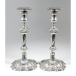 A good pair of early George III cast silver pillar candle sticks, the square sconces with French