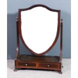 An Edwardian mahogany framed shield shaped toilet mirror in "George III" manner, inset with bevelled
