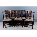 A pair of mahogany dining chairs of "Country Chippendale" design with shaped crest rails, fretted