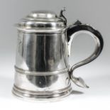 A George I silver lidded tankard, the domed moulded lid with moulded scroll thumbpiece, tapered body