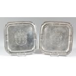 A pair of George V "Irish" cast silver square waiters of early 18th Century design with moulded